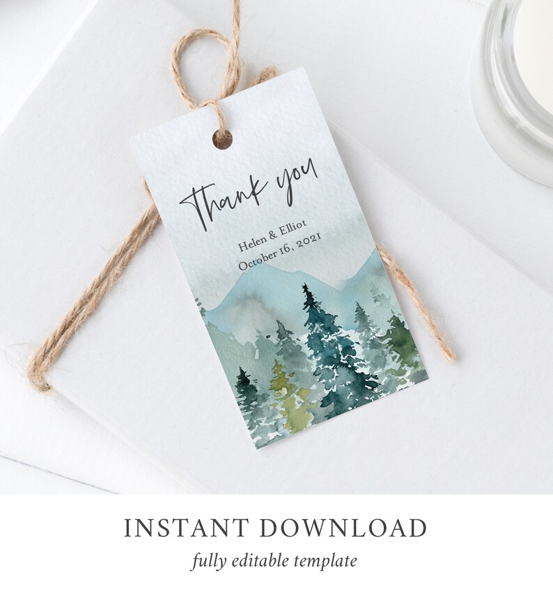 May include: A watercolor thank you tag with a mountain and forest scene in shades of blue and green. The text reads "Thank you" with the names "Helen & Elliot" and the date "October 16, 2021".
