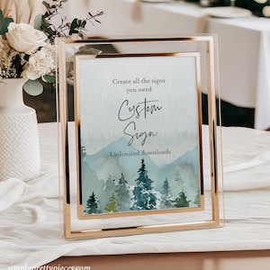 May include: A gold-framed sign with a watercolor background of a forest scene. The text on the sign reads "Create all the signs you need Custom Sign Unlimited downloads".