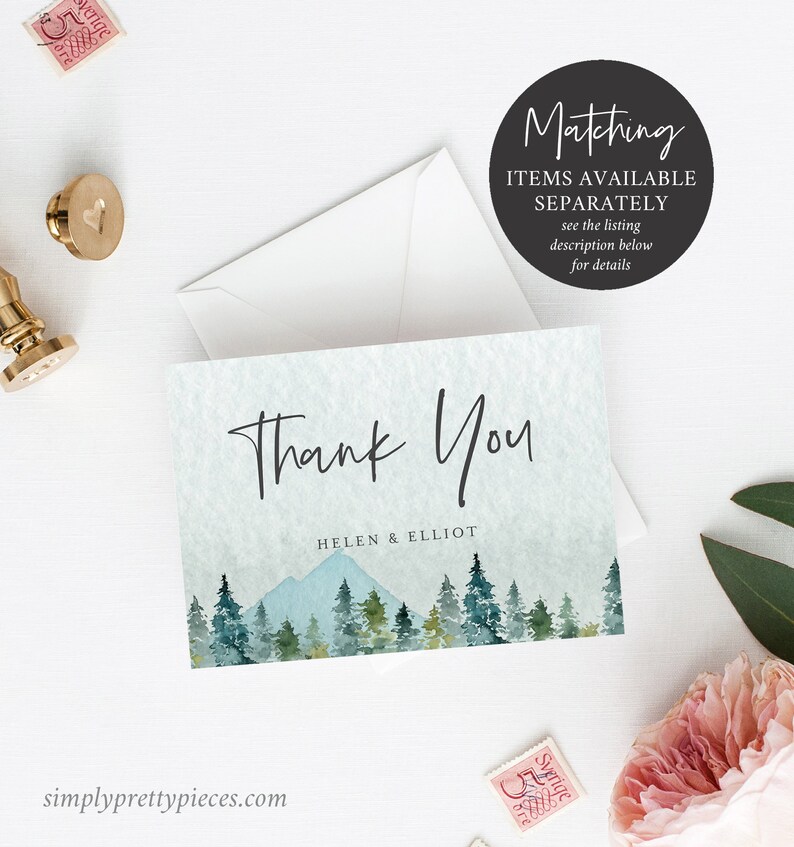May include: Thank You card with a watercolor illustration of a mountain range and pine trees in shades of blue and green. The text "Thank You" is written in a handwritten font and the names "Helen & Elliot" are printed below.
