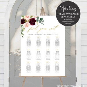 May include: A white seating plan on an easel, decorated with burgundy, blush, and green floral elements. The text "find your seat" is displayed, along with the names Paige and Marcus and the date August 25, 2023. Additional text reads "Matching items available separately".
