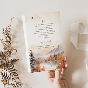 May include: A sympathy card with a watercolor illustration of a forest scene with a lake and mountains. The card has a message of remembrance for a loved one who has passed away. The text reads: "Ded We will always remember that special smile, that caring heart, that warm embrace, you always gave us. You being there for Mom and us, through good times and bad, no matter what. We will always remember you Dad because there will never be another one to replace you in our hearts and the love that we will always have for you. Arrangement Shaan will be buried with his family in Summer Valley Memorial Cemetery."