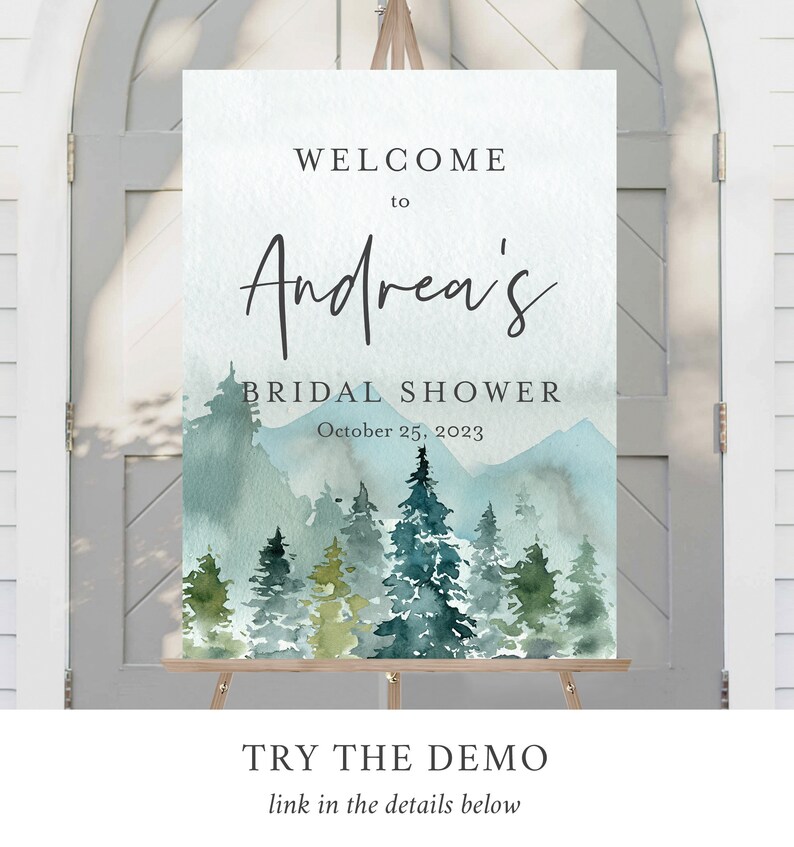 Op de afbeelding: Een aquarel-illustratie van een boslandschap met bergen op de achtergrond. De tekst "WELCOME to Andrea's BRIDAL SHOWER October 25, 2023" staat op het bord gedrukt.