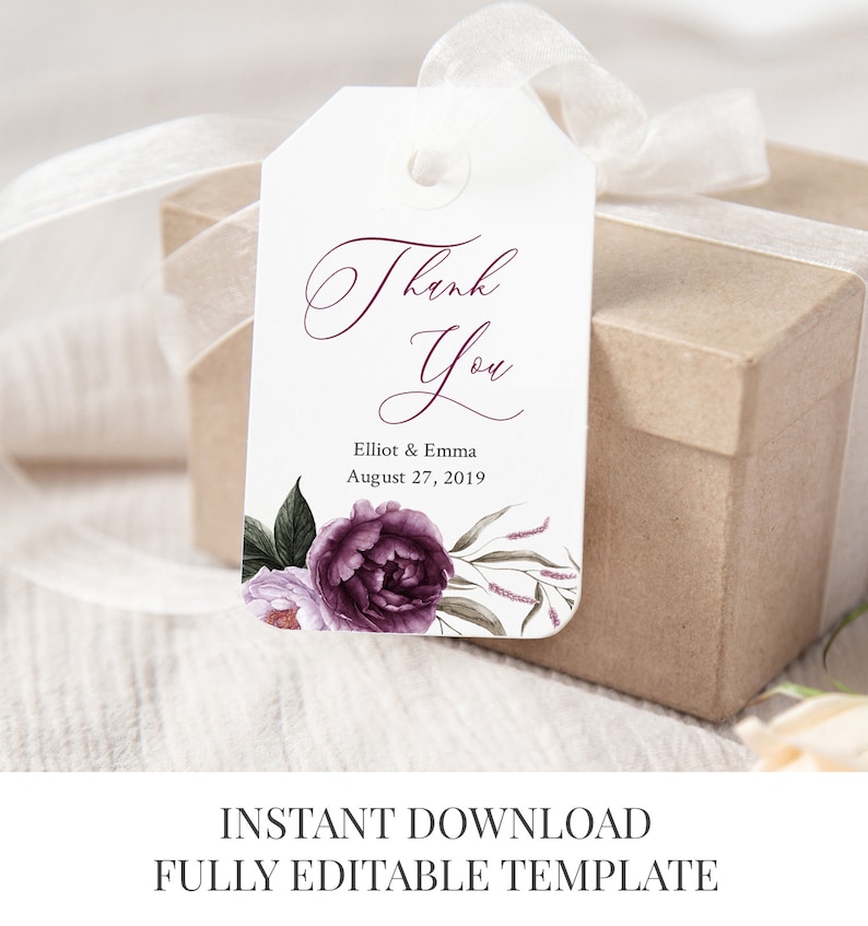 May include: A white wedding favor tag with a purple floral design and the text "Thank You" in a cursive font. The tag also includes the names "Elliot & Emma" and the date "August 27, 2019".
