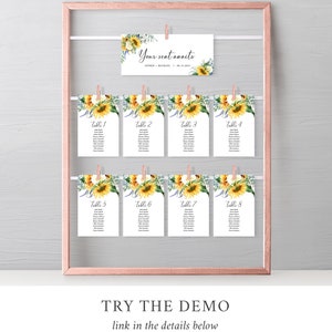 K&ouml;nnte beinhalten: Ein Satz von acht Tischkarten mit Sonnenblumen-Motiv f&uuml;r eine Hochzeit oder eine andere Veranstaltung. Jede Karte zeigt ein Sonnenblumen-Design und den Text "Tisch 1" bis "Tisch 8". Die Karten h&auml;ngen an einem Drahtgestell mit W&auml;scheklammern.
