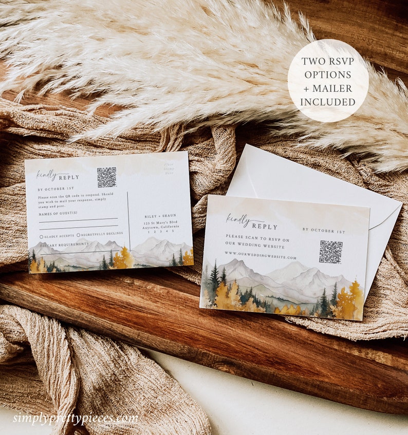 May include: Two RSVP cards with a mountain and forest watercolor design. The cards have a QR code and text that says "kindly reply" and "please scan to RSVP on our wedding website".
