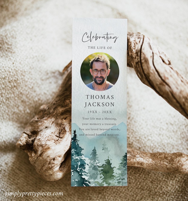 May include: A blue and green watercolor bookmark with a photo of a man and the text "Celebrating the Life of Thomas Jackson 19XX - 20XX Your life was a blessing, your memory a treasure. You are loved beyond words, and missed beyond measure."