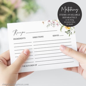 May include: A blank recipe card with a floral design in shades of pink, yellow, and green. The card has lines for writing ingredients, directions, and servings. The text "Recipe" is written at the top of the card. The text "Matching Items Available Separately" is written at the top right corner of the card.