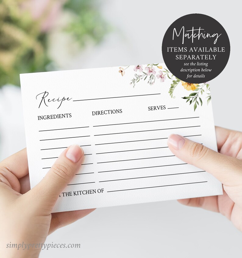 May include: A blank recipe card with a floral design in shades of pink, yellow, and green. The card has lines for writing ingredients, directions, and servings. The text "Recipe" is written at the top of the card. The text "Matching Items Available Separately" is written at the top right corner of the card.