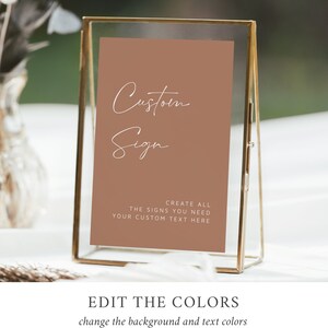 May include: A brown sign with white text that reads "Custom Sign" and "Create all the signs you need. Your custom text here." The sign is in a gold frame.