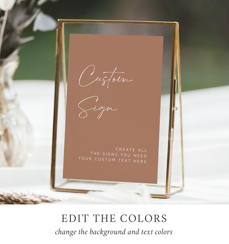 May include: A brown sign with white text that reads "Custom Sign" and "Create all the signs you need. Your custom text here." The sign is in a gold frame.