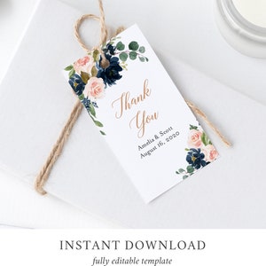 May include: A white thank you tag with a navy blue and blush floral design. The text reads "Thank You" in gold script with "Amelia & Scott August 16, 2020" below.