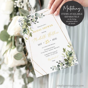 May include: A white bridal shower invitation with gold geometric borders and floral accents. The invitation includes the text "BRIDAL SHOWER" and details for the event, including the date, time, and location. The invitation is held by a person.