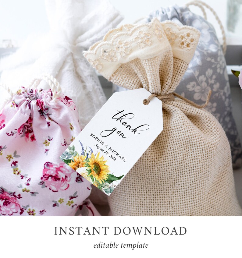 May include: White thank you tag with black calligraphy that says "Thank you" and the text "Sophie & Michael August 20, 2022". The tag has a watercolor illustration of sunflowers and greenery.