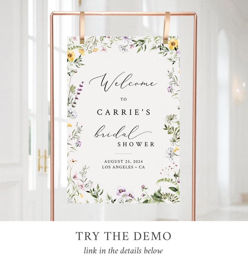 May include: A floral-themed bridal shower welcome sign with a white background and a green, yellow, and purple floral border. The text reads "Welcome to Carrie's Bridal Shower August 25, 2024 Los Angeles, CA".