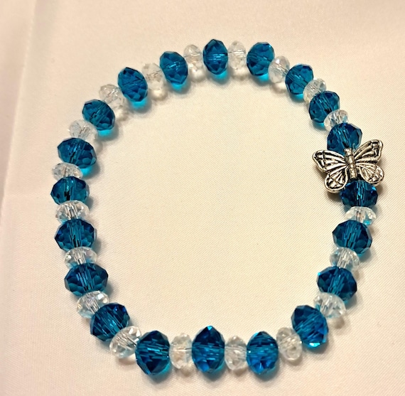 Sparkly blue crystal bracelet with butterfly accent.