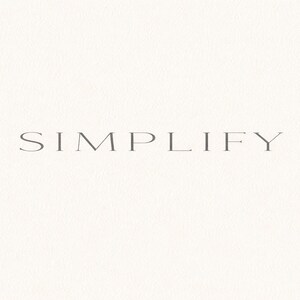 Puede incluir: La palabra "SIMPLIFY" se muestra en una fuente gris elegante sobre un fondo texturizado blanquecino. La imagen tiene una estética minimalista, con el texto centrado y el fondo que proporciona una sensación sutil y táctil.
