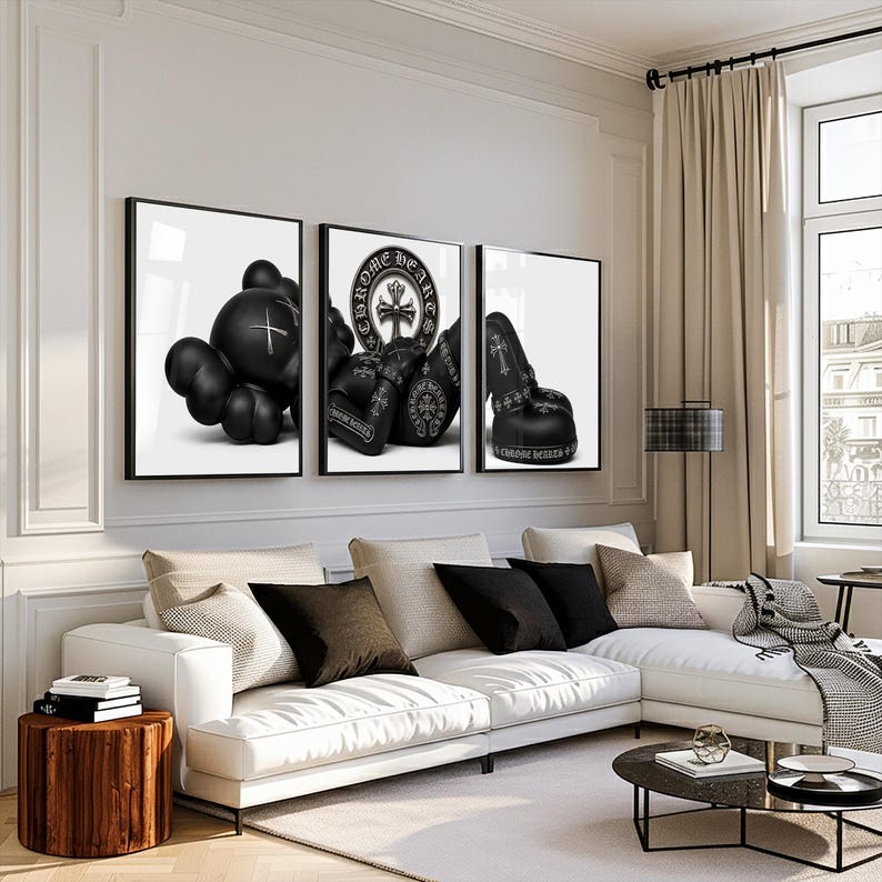 May include: Three framed wall art prints featuring black and white imagery. The left print shows a stylized character figure, the center print displays Chrome Hearts branding with a cross emblem, and the right print depicts black boxing gloves.