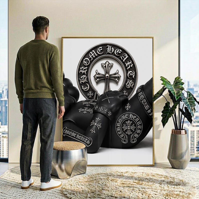 May include: A large rectangular wall art print featuring a black and white graphic design with the text CHROME HEARTS. The artwork displays a central cross emblem within a circular border, surrounded by stylized black figures adorned with cross motifs.