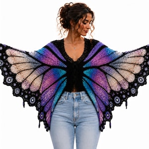 May include: A black crochet top with a butterfly wing design in shades of purple, blue, and cream. The wings are spread wide, showcasing the intricate details of the crochet work. The top has a V-neck and a tie closure.