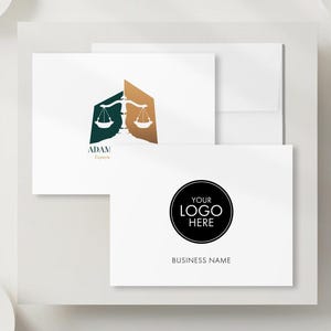 May include: A collection of white business cards and envelopes. One card features a logo with scales of justice in green and gold. Another card has a black circle with "YOUR LOGO HERE" and "BUSINESS NAME".