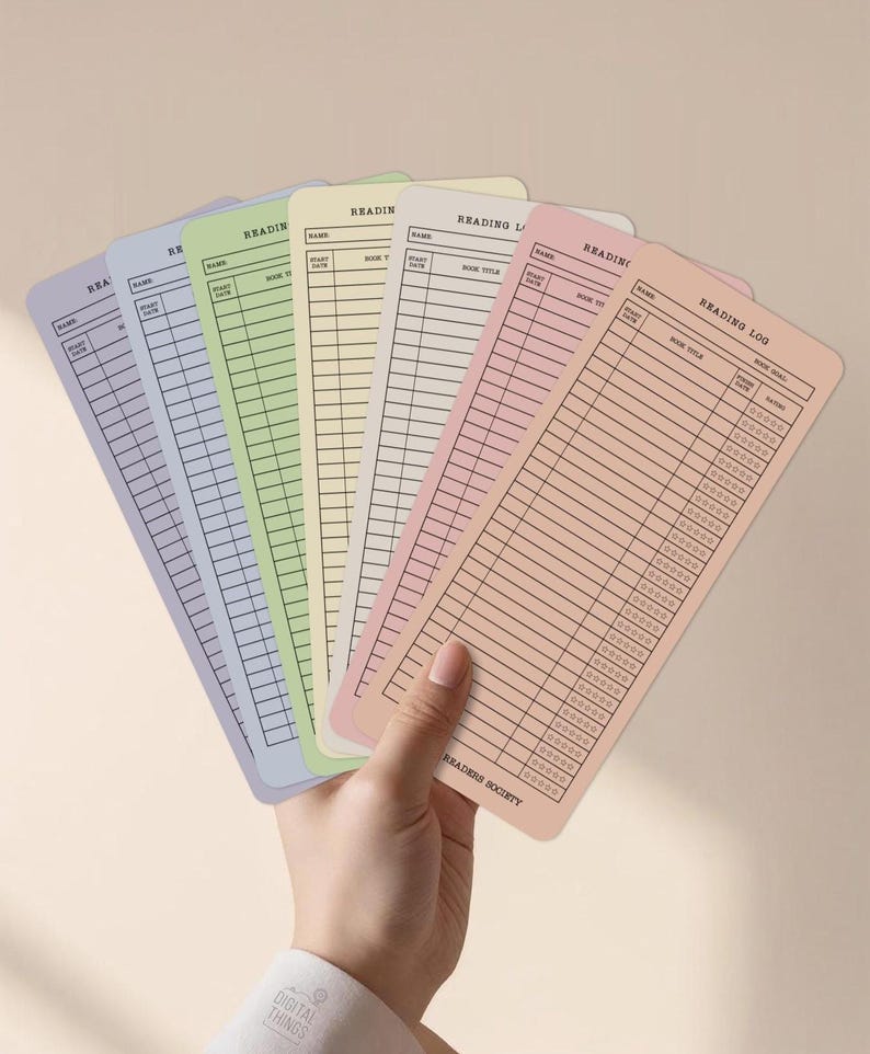 May include: A hand holds a fan of pastel-colored reading log cards. Each card has a different color, including lavender, blue, green, yellow, and peach. The cards are labeled with "Reading Log" and have spaces for book title, date, and rating.