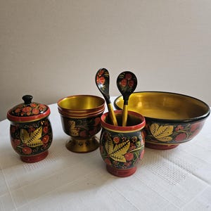 May include: A set of three ceramic mugs with a speckled, matte finish. The mugs are in shades of cream, light brown, and dark brown. Each mug has a simple, minimalist design, perfect for coffee or tea.