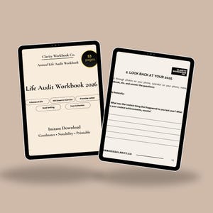 May include: Two black tablets displaying a digital workbook. The workbook is titled "Life Audit Workbook 2026" and includes sections for goal setting and self-reflection. The workbook is an instant download and printable.