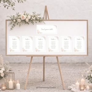May include: A wooden easel displaying a seating chart for a wedding. The chart features a white background with floral accents and the text "Find your table." Individual table cards are arranged below, each with names.