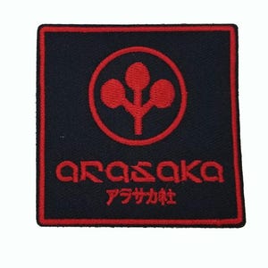 May include: A square embroidered patch featuring a black background with a red border. The design includes a red circular logo with a three-lobed symbol, the text ARASAKA in red, and the Japanese text アラサカ社 in red below the main lettering.