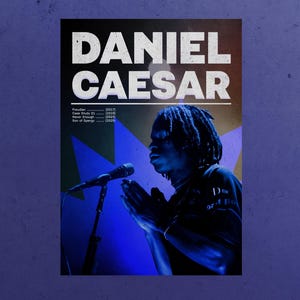 May include: A concert poster featuring the name "DANIEL CAESAR" in large white letters. The poster includes a photo of a person singing into a microphone, with blue and yellow lighting. Album titles and years are listed below.