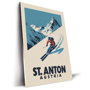 May include: A vintage-style poster featuring a skier in orange and blue attire, skiing down a snowy slope. The background shows snow-capped mountains and a blue sky. The poster reads "ST. ANTON AUSTRIA" in bold, dark blue letters.
