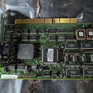 May include: A white ceramic mug with a black handle and the text "But First, Coffee" in a handwritten style. The mug is on a white surface. The mug is approximately 4 inches tall.