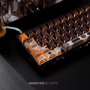 May include: A mechanical keyboard featuring custom keycaps with a black and orange color scheme. The keys display white lettering and technical graphic patterns. The keyboard is illuminated with an orange backlight, and a braided cable is attached.