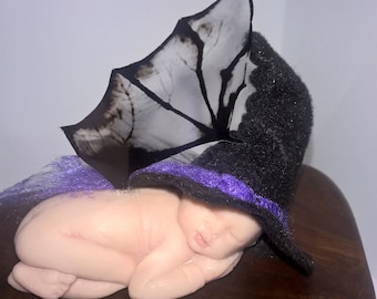 sleeping baby witch with bat wings