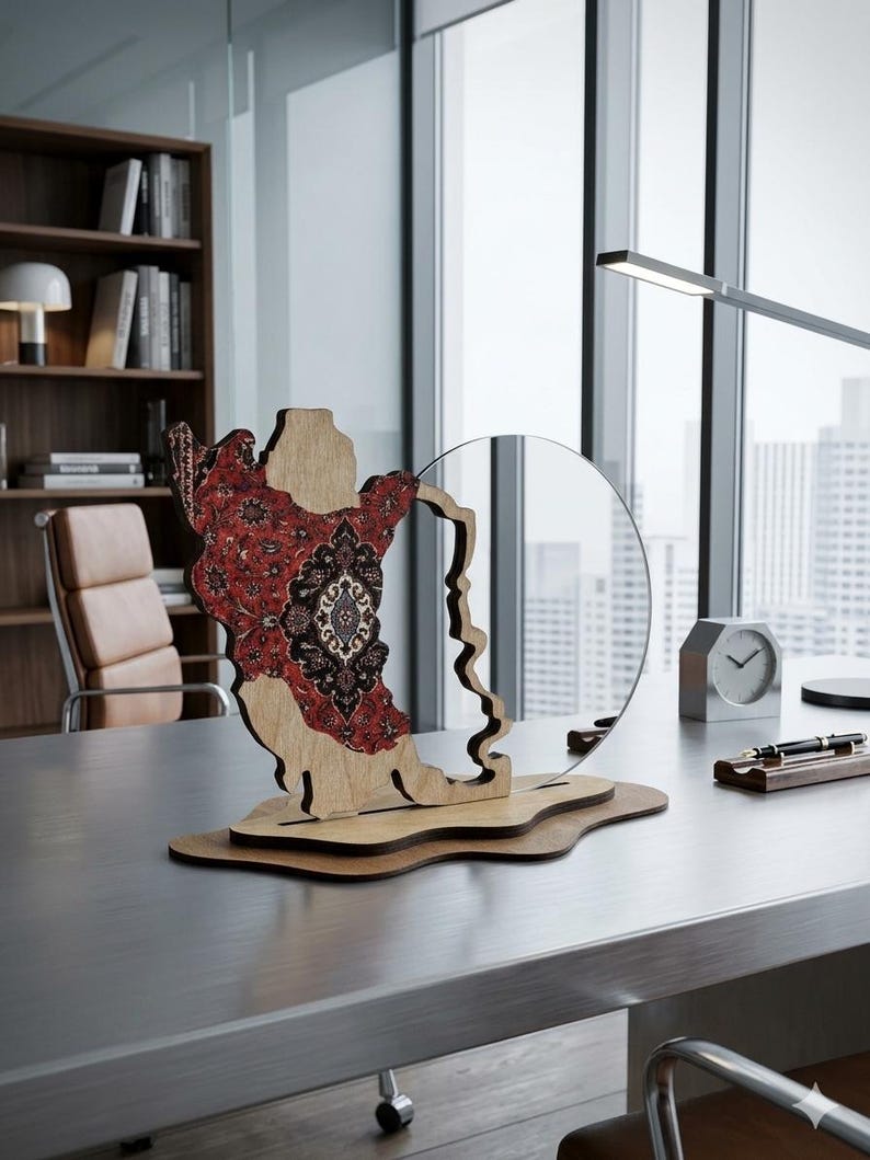 May include: A decorative wooden sculpture featuring a cutout map shape with a detailed red and black floral pattern on one side, mounted on a layered wooden base next to a circular clear acrylic panel, creating a layered display piece.