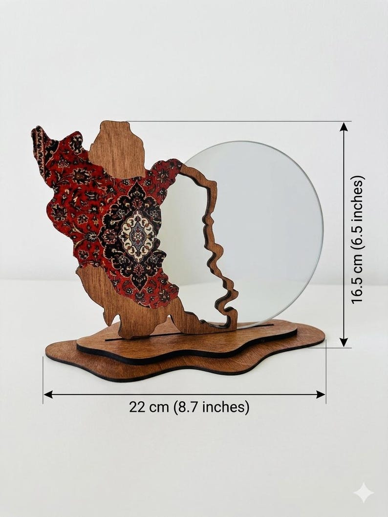 May include: A decorative wooden stand featuring a red and black patterned inlay on one side and a circular mirror on the other, mounted on a layered base. The object measures 6.5 inches in height and 8.7 inches in width as indicated by labels.
