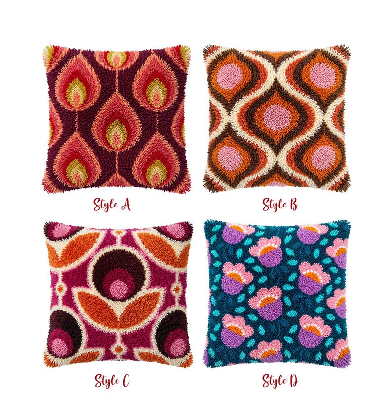 May include: Four square throw pillows with textured punch needle designs. Style A features maroon, pink, and yellow flame patterns. Style B has brown, orange, and pink interlocking shapes. Style C shows magenta, orange, and dark brown floral motifs. Style D displays teal, purple, and pink flowers.