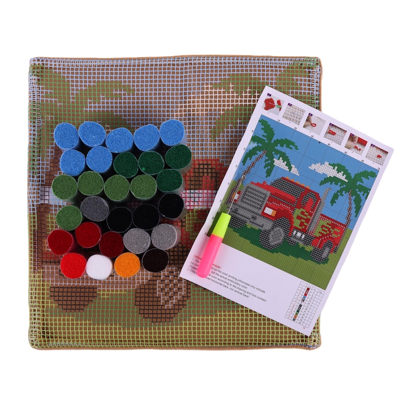 May include: A latch hook craft kit featuring a square canvas with a printed truck and palm tree design, a bundle of assorted colored yarn segments in blue, green, red, white, orange, black, and gray, and a latch hook tool with a pink and yellow handle.