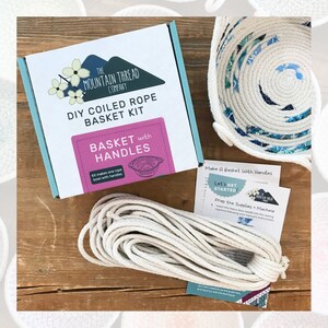 May include: A DIY coiled rope basket kit from The Mountain Thread Company. The kit includes a spool of natural colored rope, instructions, and a finished example of a basket with handles. The kit makes one rope bowl with handles.