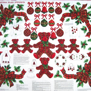 May include: A white fabric panel featuring Christmas-themed appliqués. The design includes red plaid teddy bears, ornaments, bells, bows, and holly leaves. The text "CHRISTMAS PLAID APPLIQUES" is printed at the top.