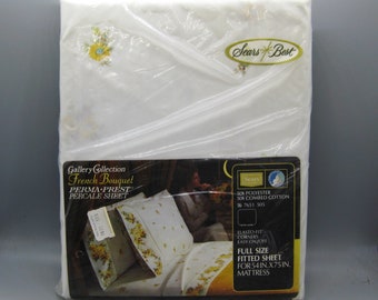 May include: A packaged full-size fitted sheet from the Sears Best Gallery Collection. The sheet is white with a floral design and the words "French Bouquet" are printed on the packaging. The package is for a 54 in. x 75 in. mattress.