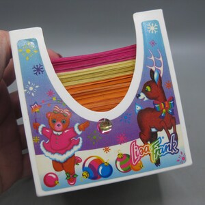 May include: A set of three ceramic mugs with a speckled, matte finish. The mugs are in shades of cream, light brown, and dark brown. Each mug has a simple, minimalist design and a rounded handle.