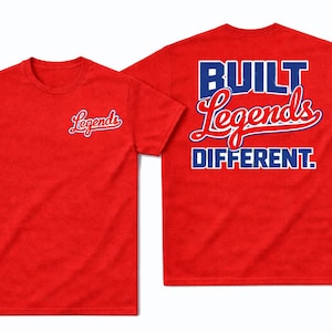 May include: Red t-shirts with the word "Legends" in a script font on the front and "BUILT Legends DIFFERENT" on the back in blue and white lettering. The shirts are displayed on a white background.