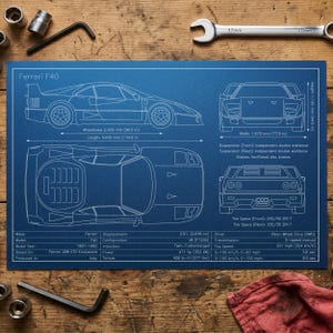 May include: A blueprint-style poster of a Ferrari F40, showcasing side, front, top, and rear views with detailed specifications. The poster is on a blue background with white lines and text, including measurements in inches. Tools like wrenches and hex keys are visible.