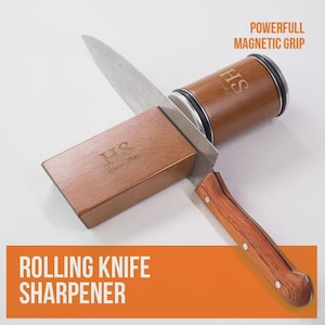 May include: Rolling knife sharpener with a wooden handle and accents. The sharpener has a powerful magnetic grip and the text "HS" is visible on the wooden components. The text "Rolling Knife Sharpener" is displayed in an orange box.