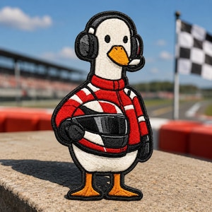 May include: An embroidered patch featuring a white duck wearing a red and white racing jacket, black gloves, and a headset with a microphone. The duck is holding a red and white racing helmet with a black visor under its arm.