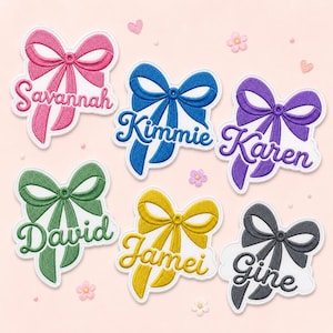 May include: Six embroidered patches shaped like bows in pink, blue, purple, green, yellow, and black. Each patch features a name stitched in cursive script: Savannah, Kimmie, Karen, David, Jamei, and Gine. The patches have a white border.