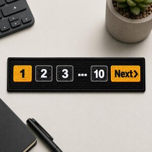 May include: A rectangular black embroidered patch featuring a horizontal row of buttons. The design includes a yellow button with the number 1, followed by grey buttons labeled 2, 3, and 10, separated by an ellipsis, and a yellow Next button.