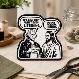 May include: A black and white embroidered patch featuring George Washington holding a document labeled WE THE PEOPLE and Jesus. Speech bubbles contain the text IT'S LIKE THEY AREN'T EVEN LISTENING and DUDE, I KNOW. The patch has a black border.