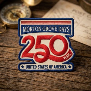 May include: Embroidered patch with the text "MORTON GROVE DAYS 250 YEARS UNITED STATES OF AMERICA". The patch has a blue border with red and white accents. The number 250 is in red, and the background is off-white.